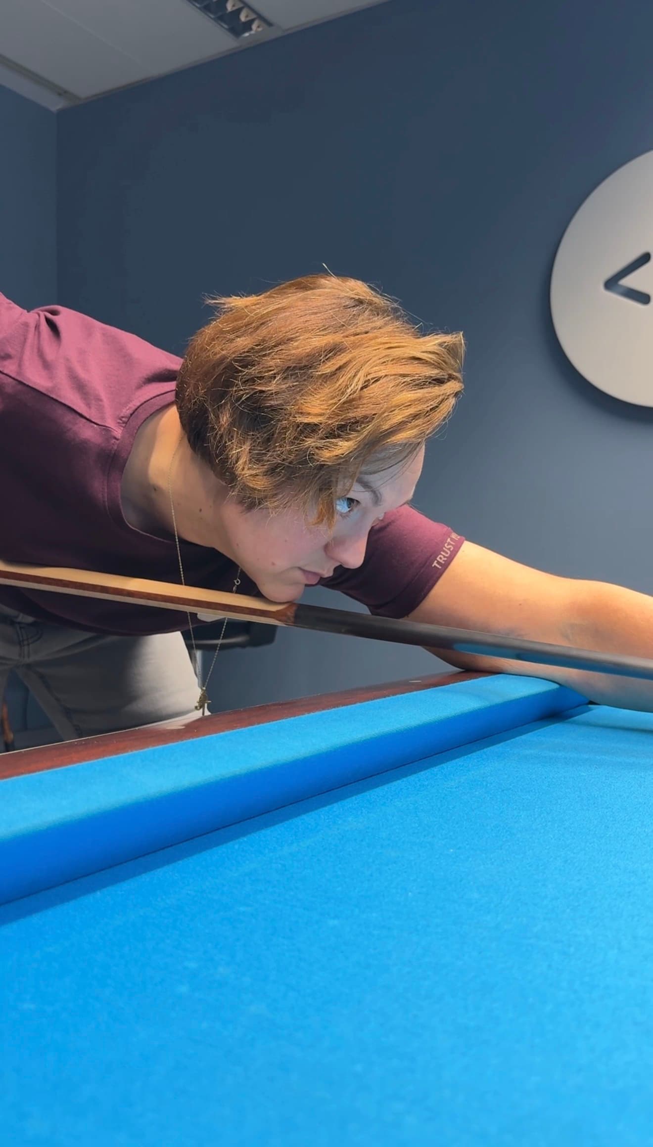 A ball on a pool table in a dark, atmospheric room.